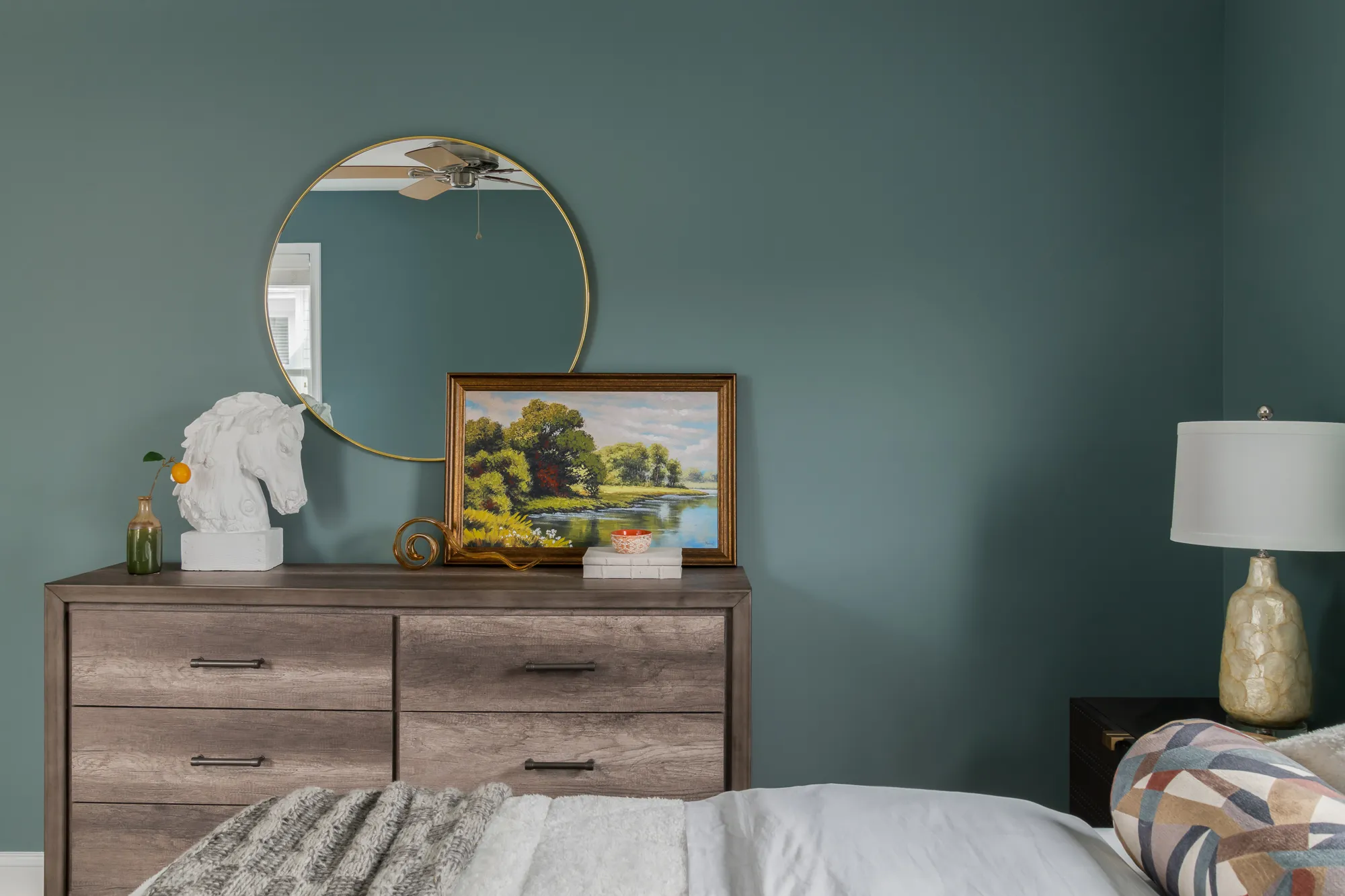 Teal room dresser with horse bust and landscape painting