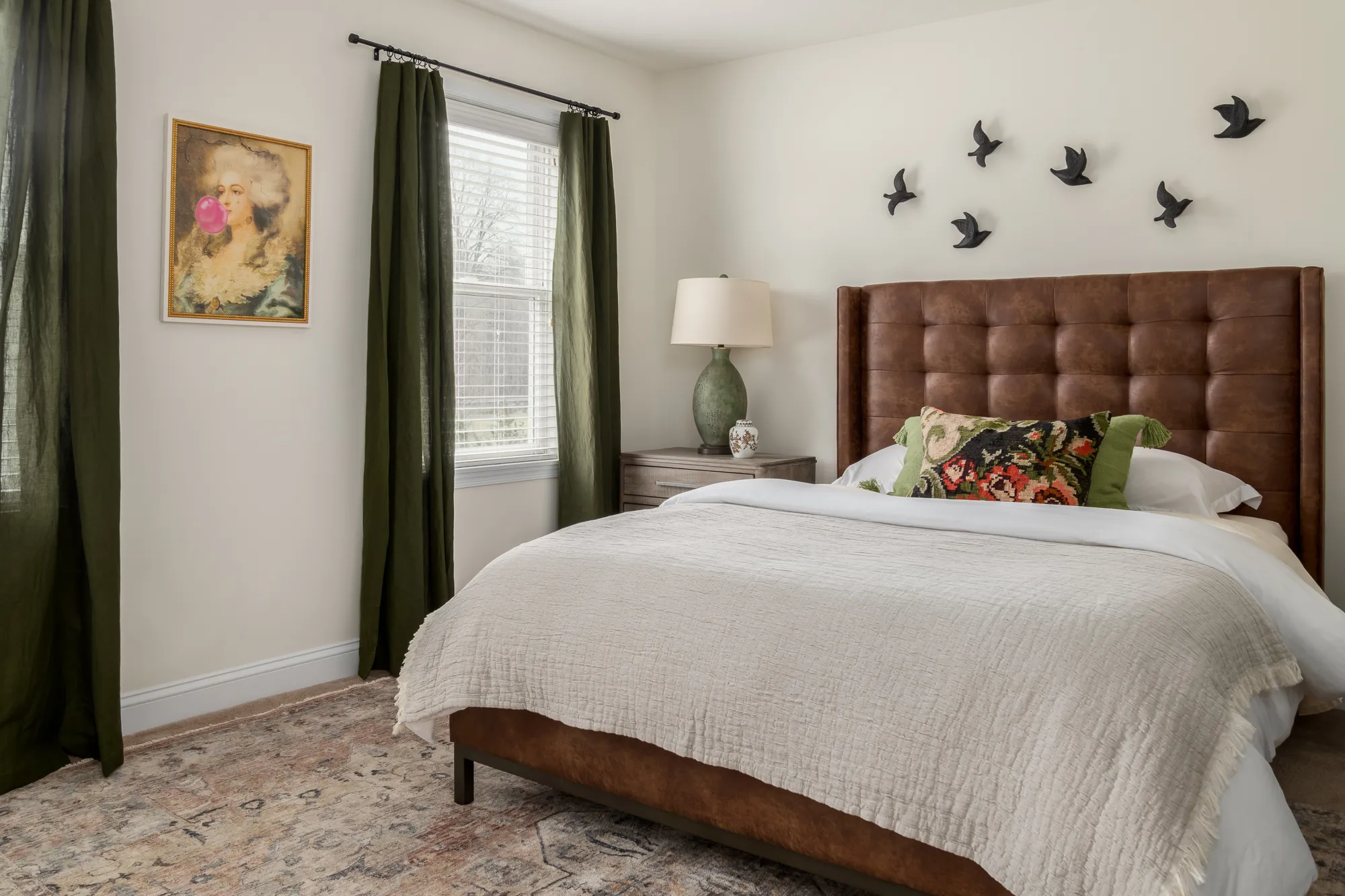 Guest bedroom with green curtains and bubblegum painting