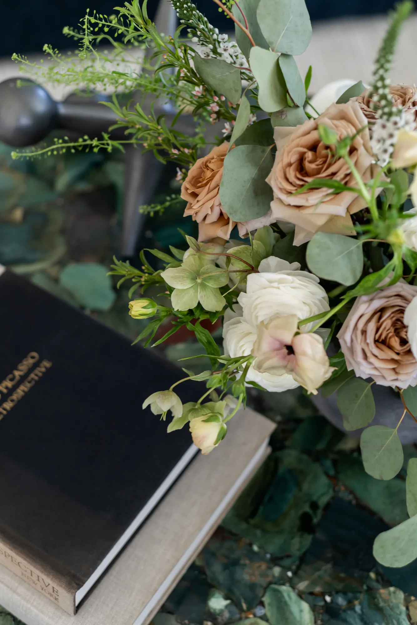 Caramel roses and eucalyptus arrangement on green stone coffee table